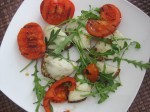 light snack: roasted sunflower bread with melted cheese, fresh rucola and grilled tomatoes